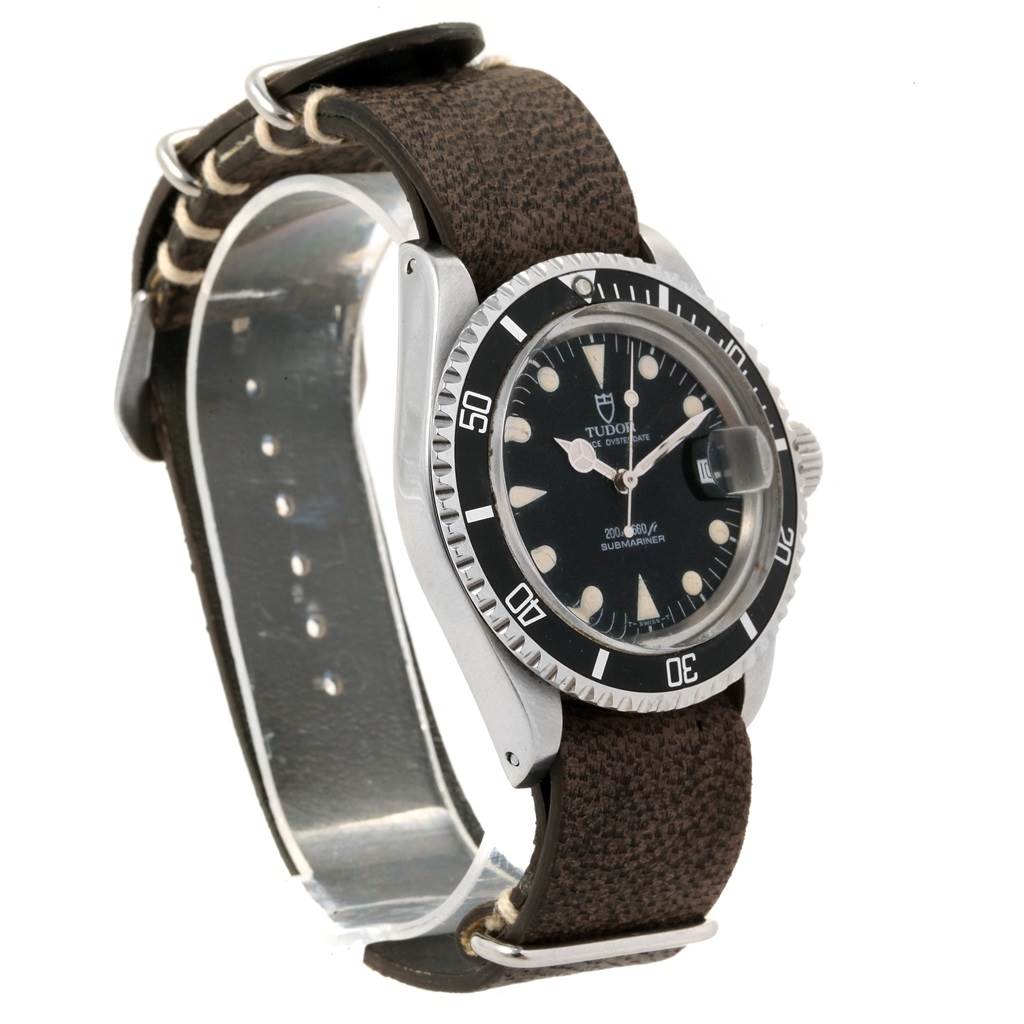 The image shows a Tudor Submariner 79090 Men's Stainless Steel Black Dial 79090 Men's Stainless Steel Black Dial watch at a slight side angle, displaying its dial, bezel, and fabric strap.