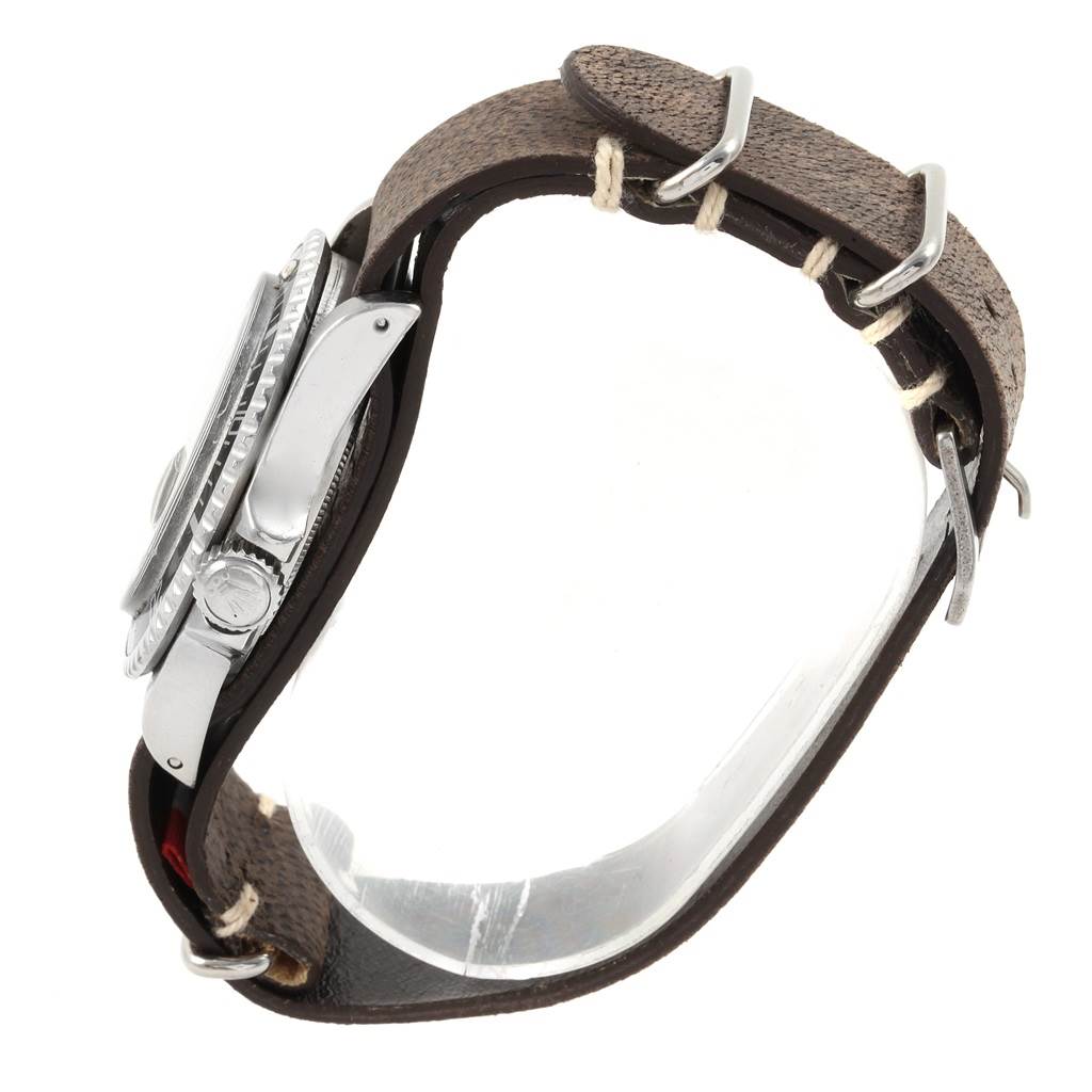 The image shows a side view of a Tudor Submariner 79090 Men's Stainless Steel Black Dial 79090 Men's Stainless Steel Black Dial watch with a brown leather strap and visible crown.