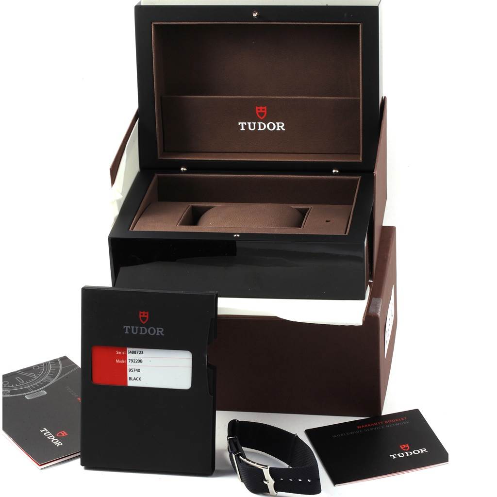 The image shows the packaging, documentation, and strap accessories for the Tudor Heritage Black Bay 79220 Men's Stainless Steel Black Dial 79220 Men's Stainless Steel Black Dial watch.