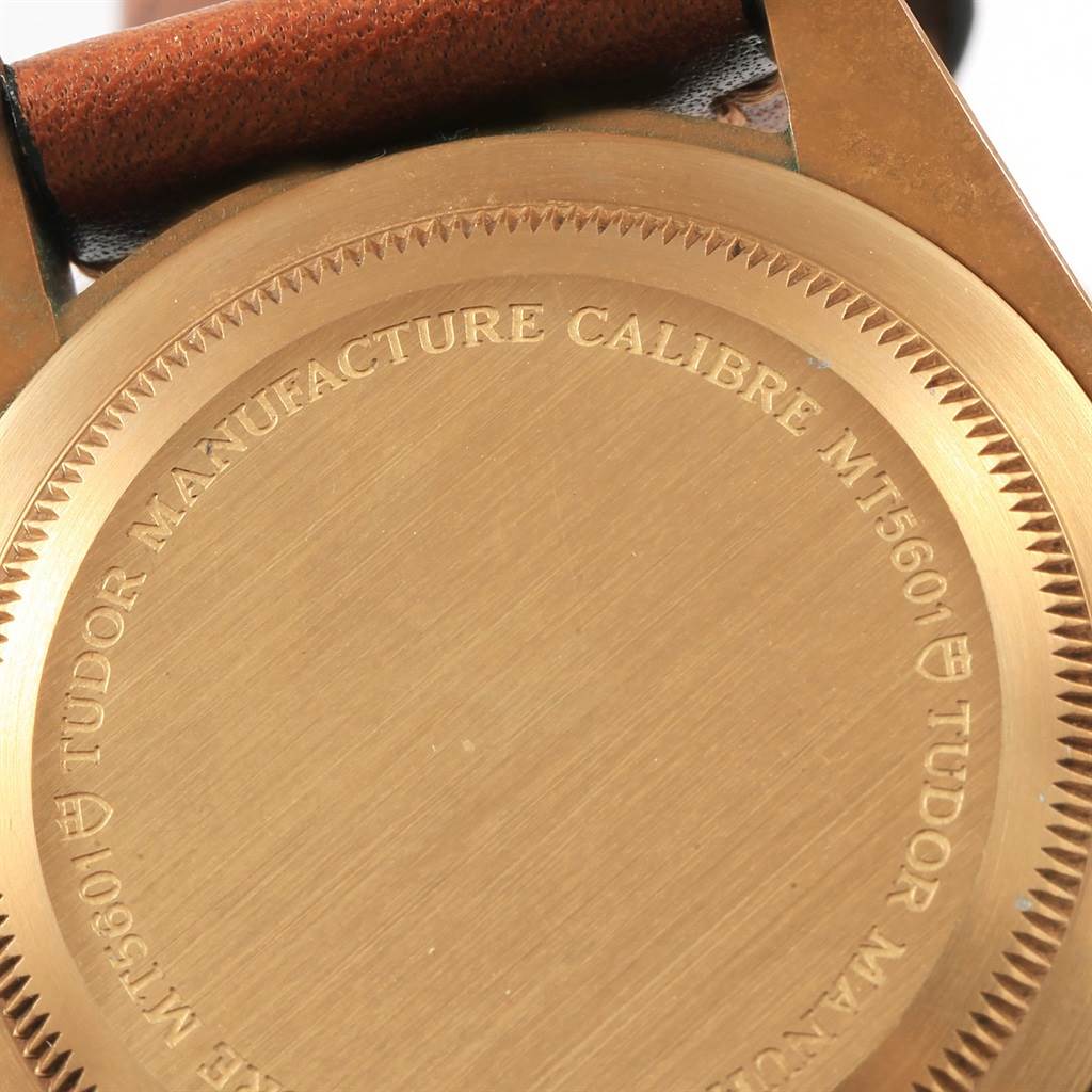 The image shows the case-back of the Tudor Heritage Black Bay 79250B Men's Bronze Brown Dial 79250B Men's Bronze Brown Dial watch, featuring engraved text and part of the strap.