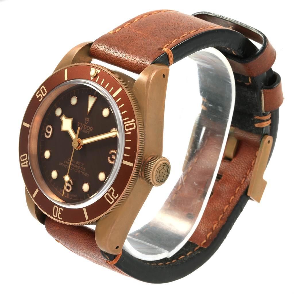 The Tudor Heritage Black Bay 79250B Men's Bronze Brown Dial 79250B Men's Bronze Brown Dial watch is shown at an angle displaying the face, bezel, crown, and part of the leather strap.