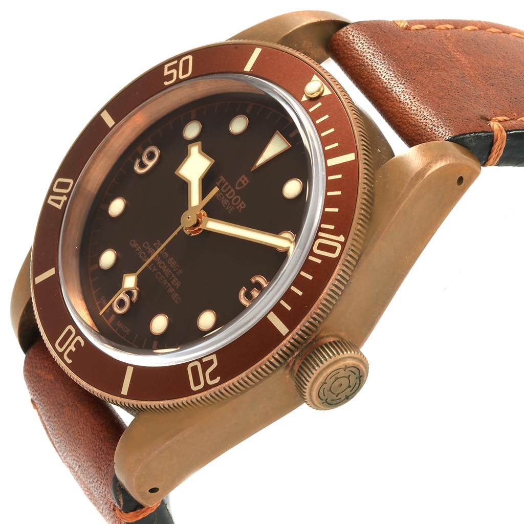 The image shows a Tudor Heritage Black Bay 79250B Men's Bronze Brown Dial 79250B Men's Bronze Brown Dial watch from a side angle, highlighting its dial, bezel, crown, and leather strap.