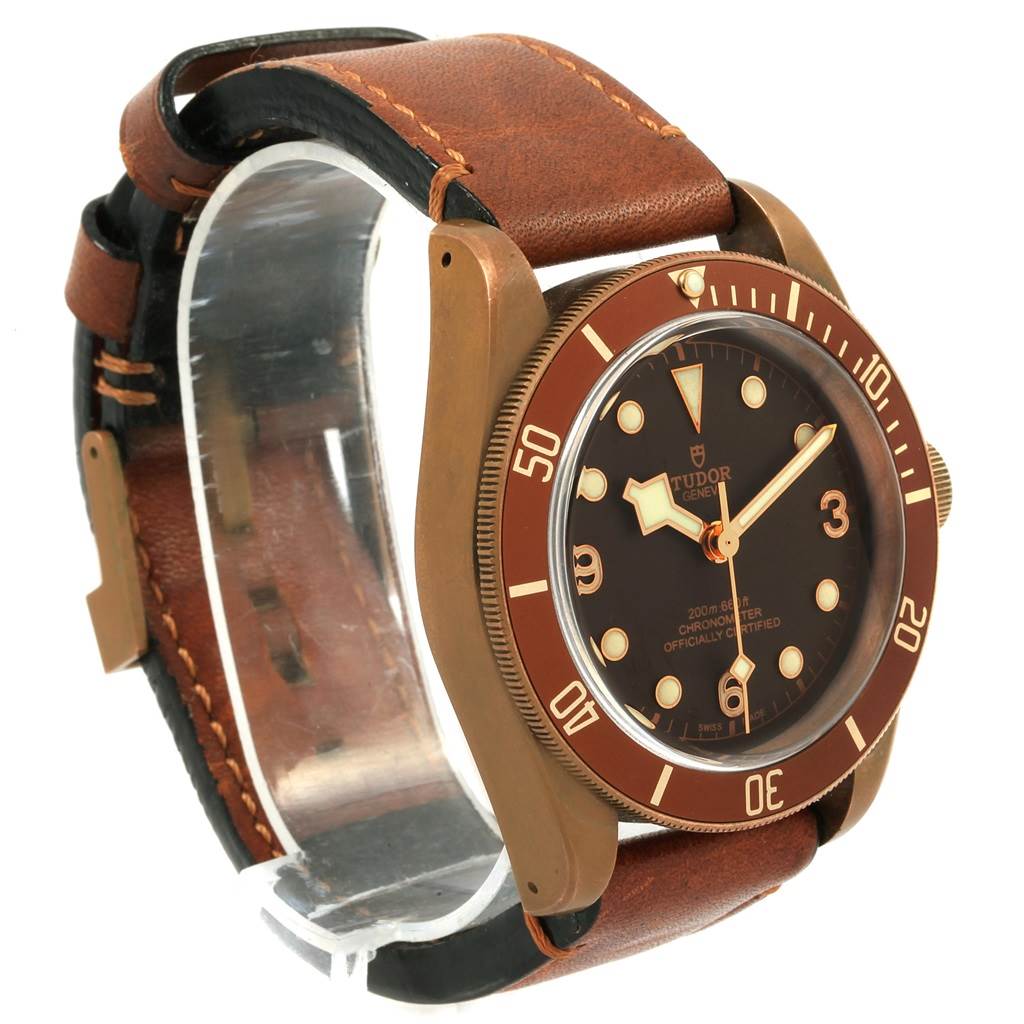 The image shows a Tudor Heritage Black Bay 79250B Men's Bronze Brown Dial 79250B Men's Bronze Brown Dial watch from an angled side view, highlighting its bezel, dial, and leather strap.