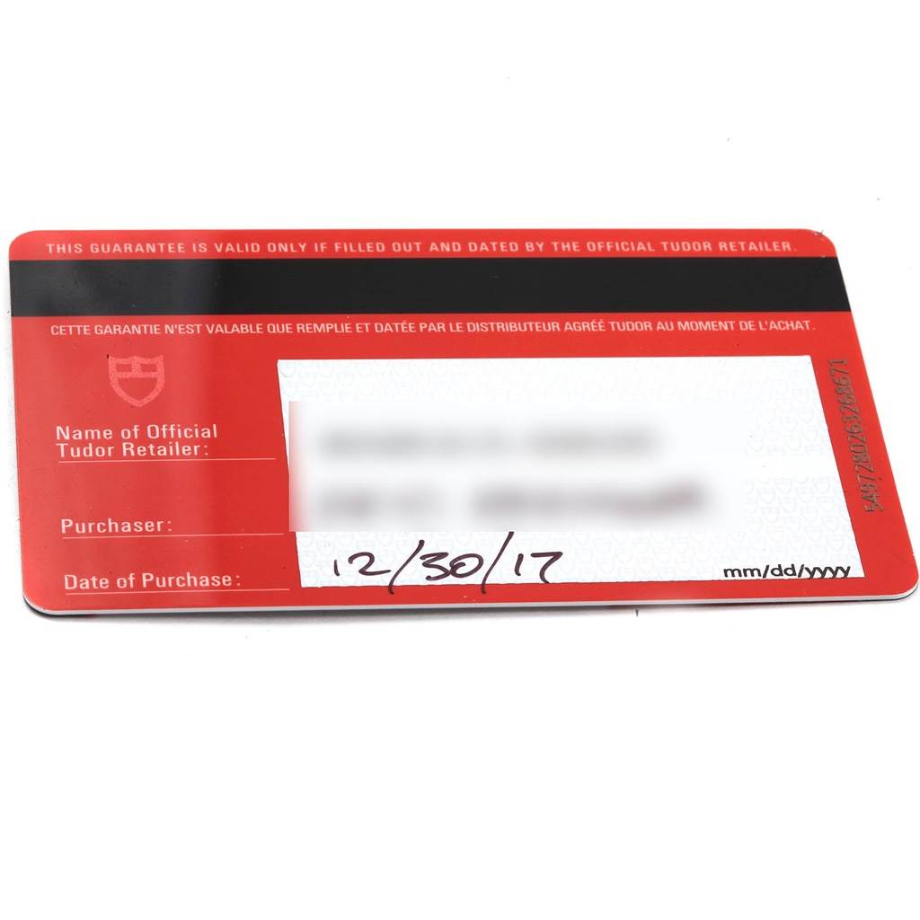 This image shows a guarantee card from Tudor for the Heritage Black Bay model, viewed from the front.