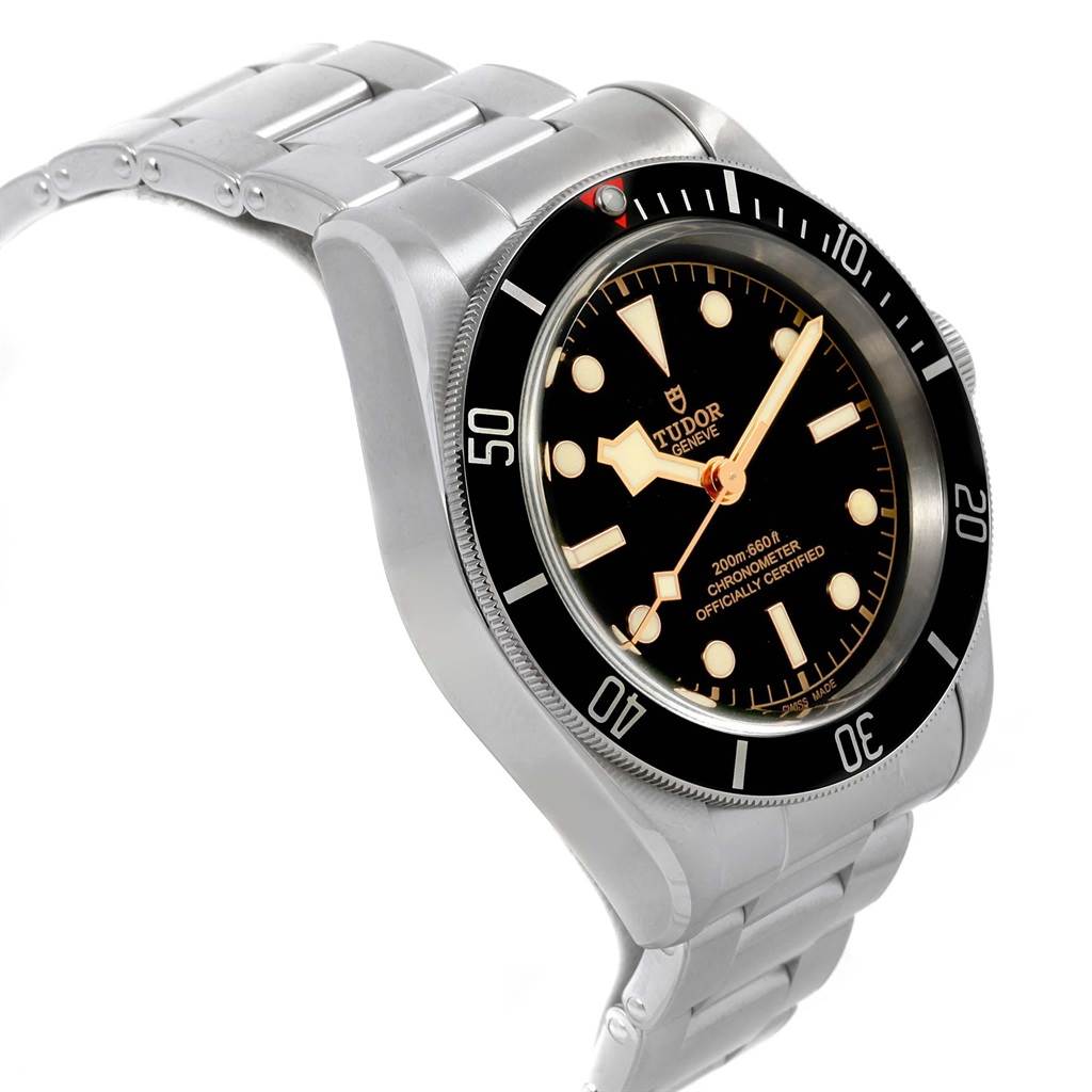The image shows a Tudor Heritage Black Bay 55020 Men's Stainless Steel Black Dial 55020 Men's Stainless Steel Black Dial watch angled from the top right, highlighting its dial, bezel, and metal bracelet.