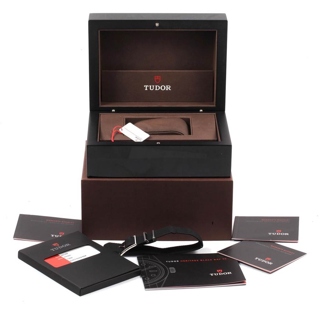 The image shows the open packaging and accessories of a Tudor Heritage Black Bay 55020 Men's Stainless Steel Black Dial 55020 Men's Stainless Steel Black Dial watch, including a presentation box and various manuals.
