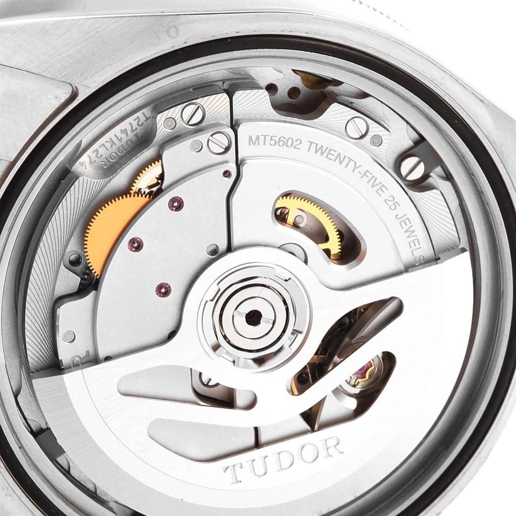 The image shows a close-up of the movement mechanism of a Tudor Heritage Black Bay 55020 Men's Stainless Steel Black Dial 55020 Men's Stainless Steel Black Dial watch, highlighting gears and internal components.