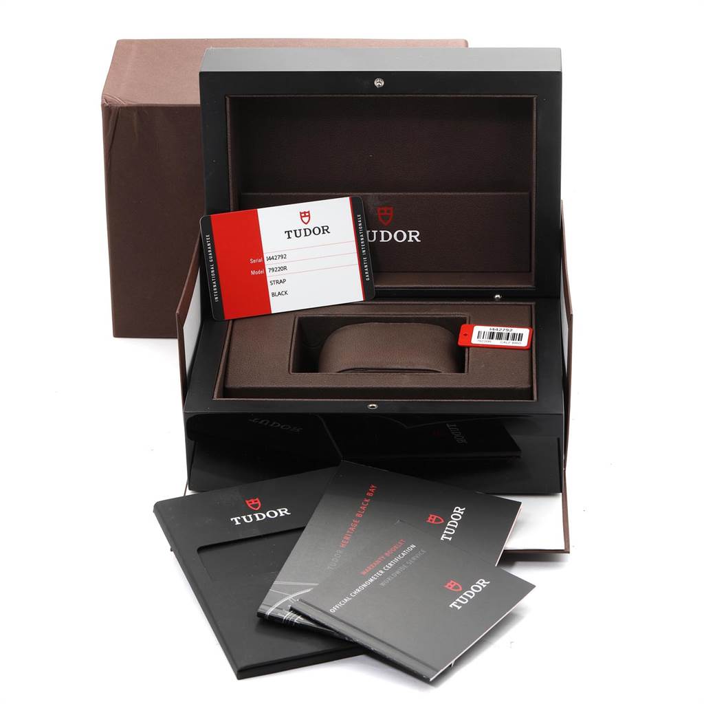 The image shows the Tudor Heritage Black Bay 79220R Men's Stainless Steel Black Dial 79220R Men's Stainless Steel Black Dial watch packaging, including the watch box, warranty card, and manuals.
