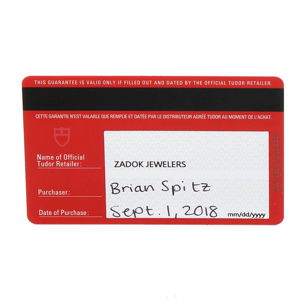 This image shows the warranty card for the Tudor Heritage Black Bay 79220R Men's Stainless Steel Black Dial 79220R Men's Stainless Steel Black Dial watch from an overhead angle.