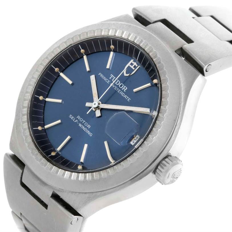 The image shows a Tudor Prince 9101/0 Men's Stainless Steel Blue Dial 9101/0 Men's Stainless Steel Blue Dial watch at an angle highlighting its dial, bezel, crown, and part of the bracelet.