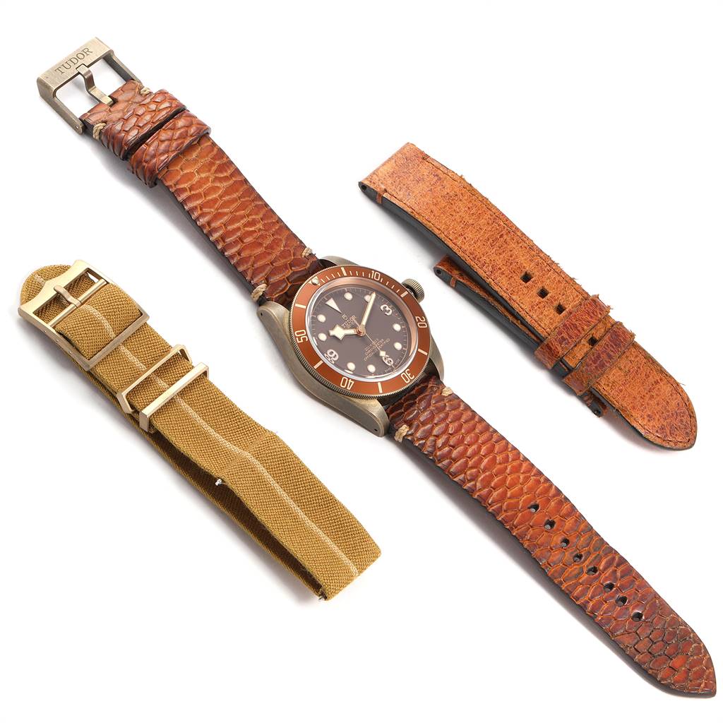 The image shows a Tudor Heritage Black Bay 79250B Men's Bronze Brown Dial 79250B Men's Bronze Brown Dial watch with two additional strap options, viewed from a top-down angle.
