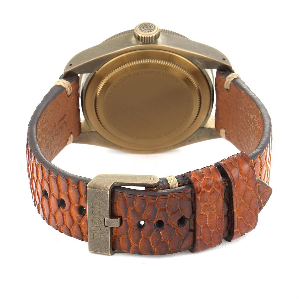The image shows the back view of a Tudor Heritage Black Bay 79250B Men's Bronze Brown Dial 79250B Men's Bronze Brown Dial watch, focusing on its leather strap and buckle.