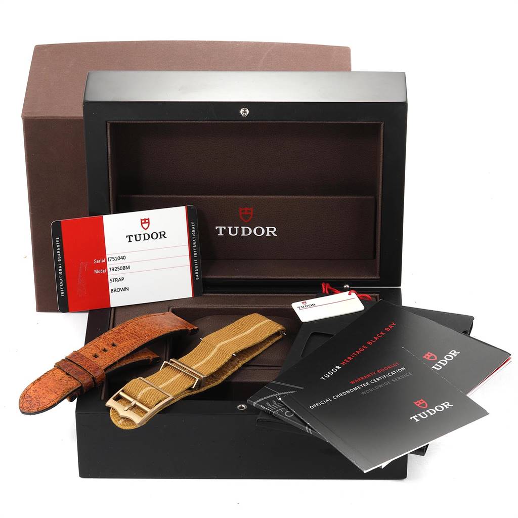 The image shows the box, warranty cards, manuals, and extra straps for the Tudor Heritage Black Bay 79250B Men's Bronze Brown Dial 79250B Men's Bronze Brown Dial watch.