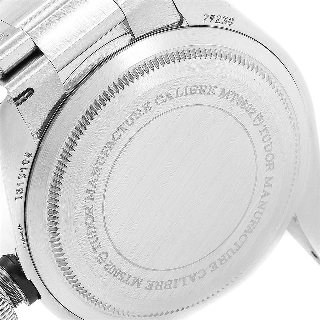 The image shows the case back of the Tudor Heritage Black Bay 79230B Men
s Stainless Steel Black Dial 79230B Men
s Stainless Steel Black Dial watch, highlighting the serial number and engraved text.