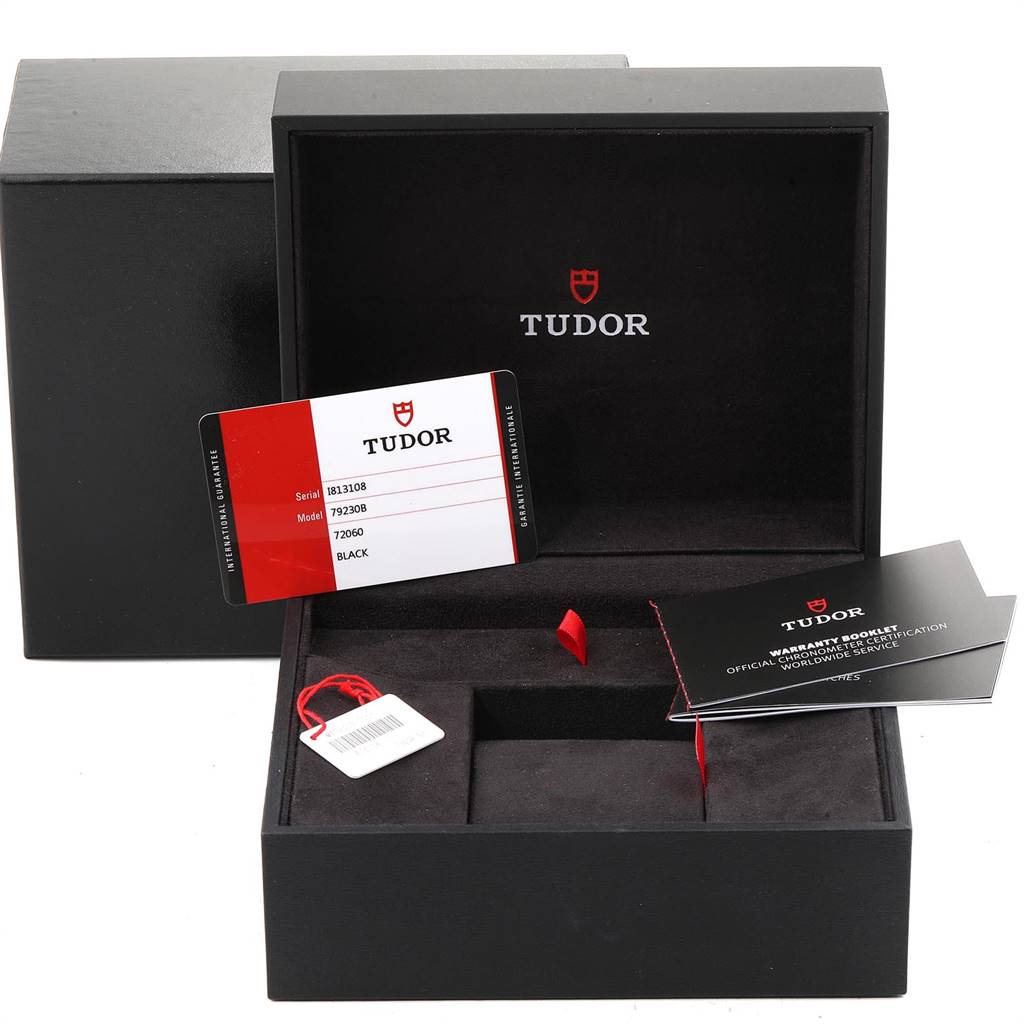 The image shows an open Tudor Heritage Black Bay 79230B Men
s Stainless Steel Black Dial 79230B Men
s Stainless Steel Black Dial watch box with papers, tags, and a warranty card visible.