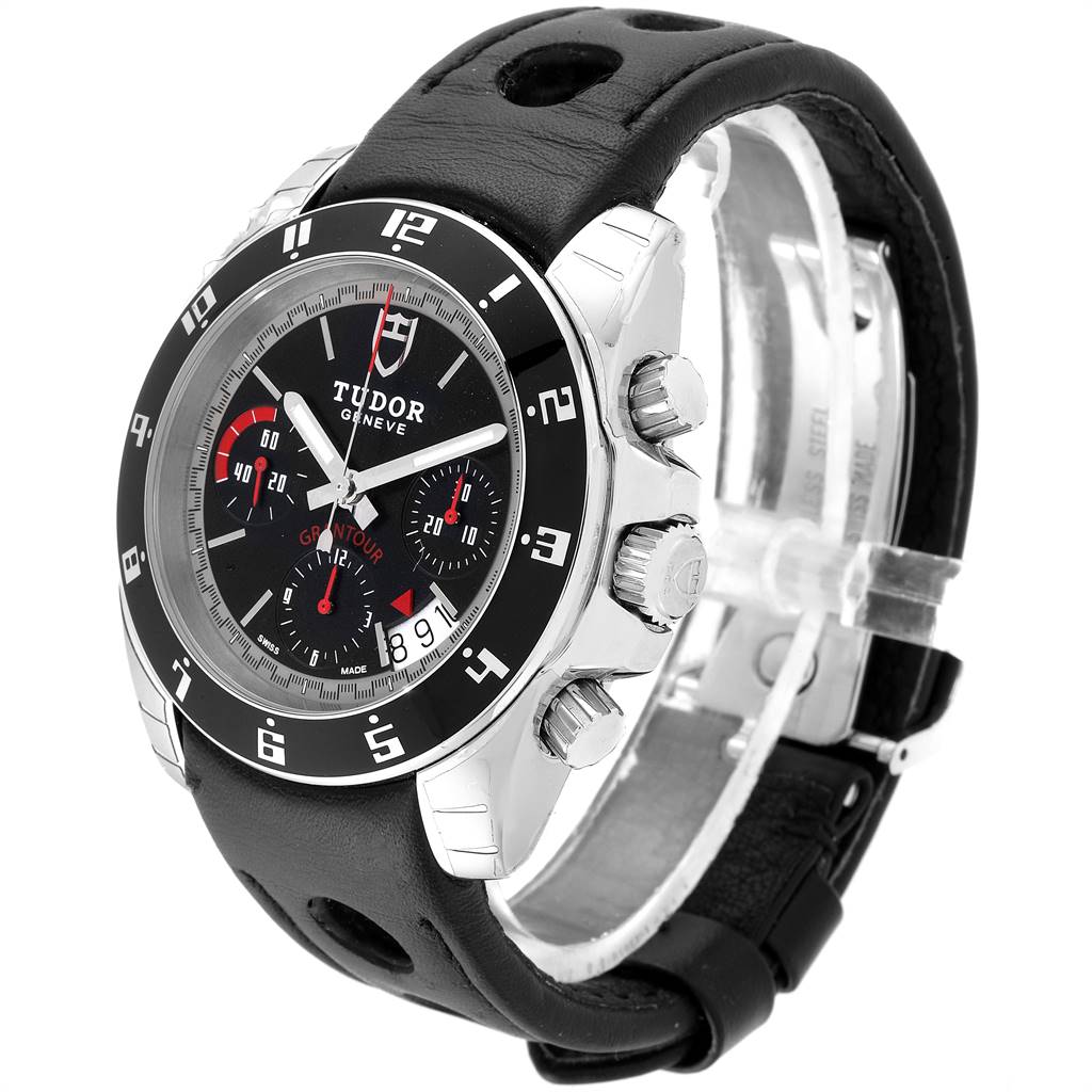 The image shows a Tudor Grantour 20350N-BKSLPL Men
s Stainless Steel Black Dial 20350N-BKSLPL Men
s Stainless Steel Black Dial watch at a slight angle highlighting the face, crown, pushers, and leather strap with perforations.