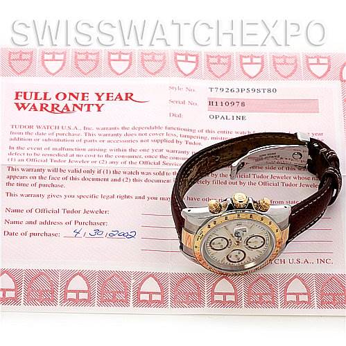 The image shows a Tudor Tiger 79263 Men's Yellow Gold Champagne Dial 79263 Men's Yellow Gold Champagne Dial model watch at a side angle with its warranty card in the background.