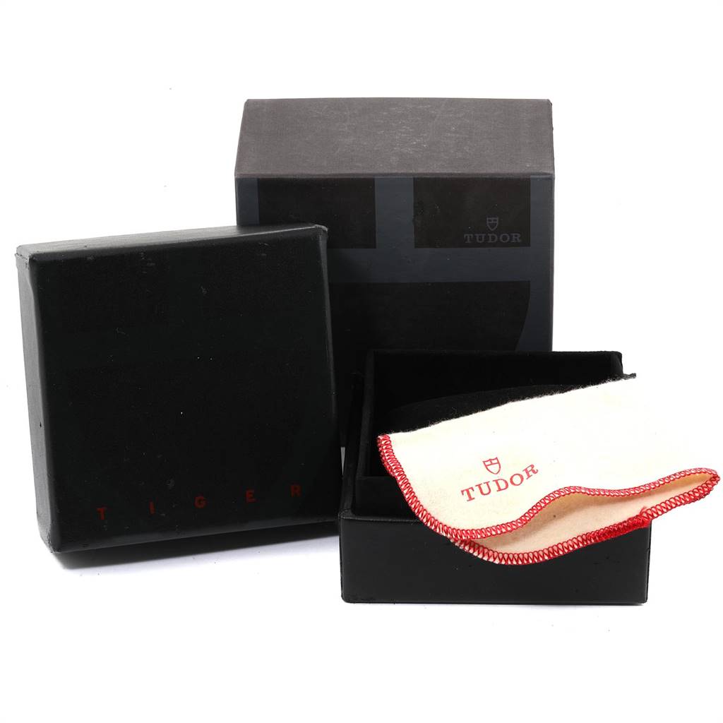 This image shows the packaging and cleaning cloth for a Tudor Tiger 79260 Men's Stainless Steel Silver Dial 79260 Men's Stainless Steel Silver Dial model watch.