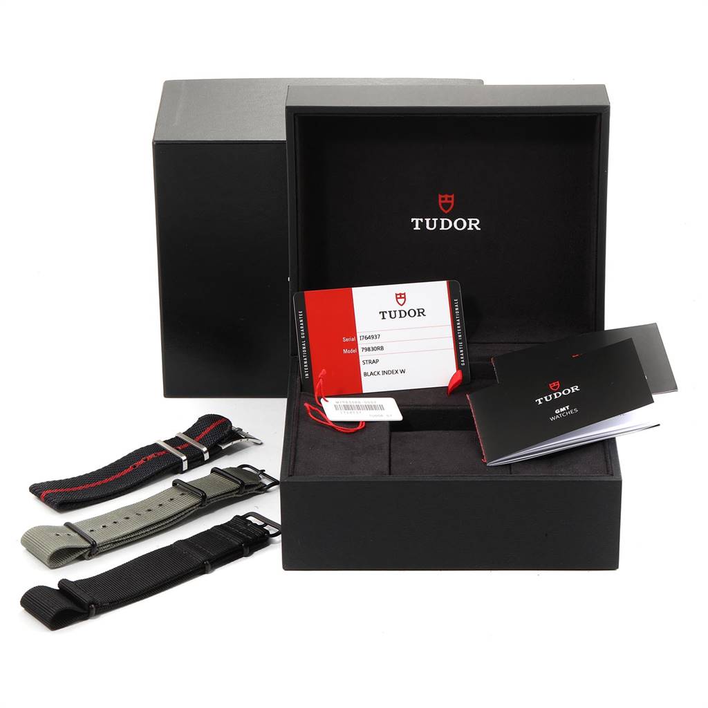 The image shows a Tudor Heritage Black Bay 79830RB Men's Stainless Steel Black Dial 79830RB Men's Stainless Steel Black Dial box, extra straps, warranty card, and booklets from a front angle.