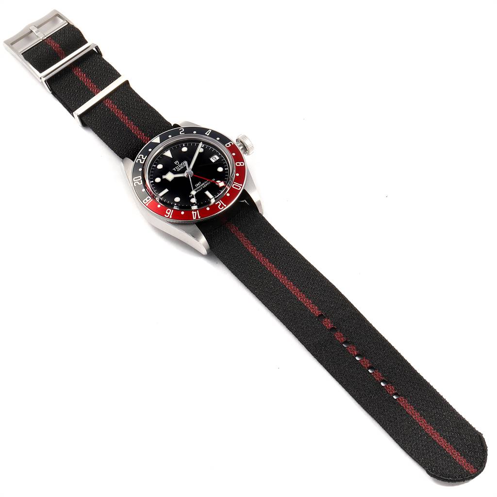 This is a top-down view of the Tudor Heritage Black Bay 79830RB Men's Stainless Steel Black Dial 79830RB Men's Stainless Steel Black Dial watch, showcasing its face, bezel, crown, and fabric strap.