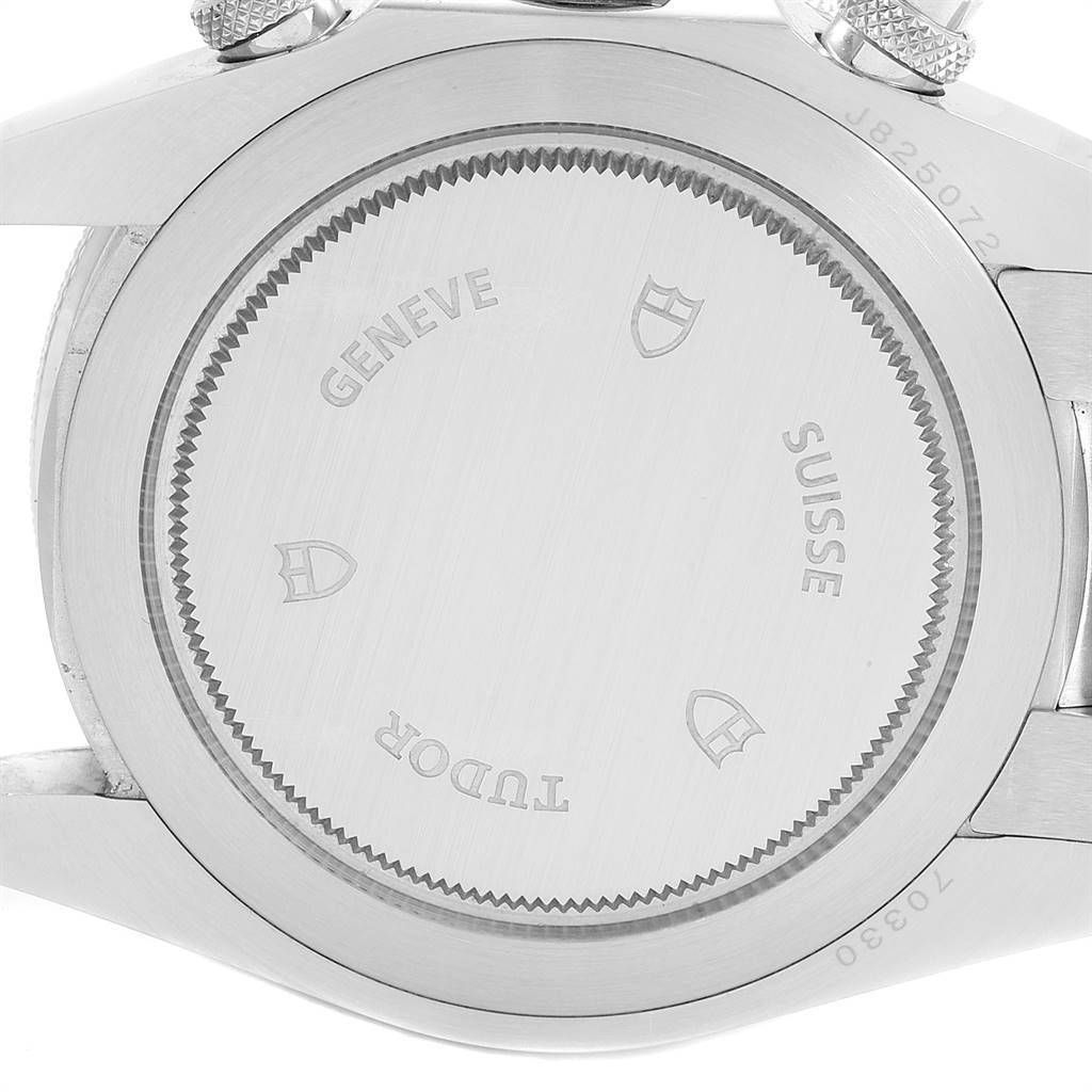 The image shows the back case of the Tudor Heritage Chrono 70330B Men
s Stainless Steel Blue Dial 70330B Men
s Stainless Steel Blue Dial watch, displaying engravings and part of the lugs.