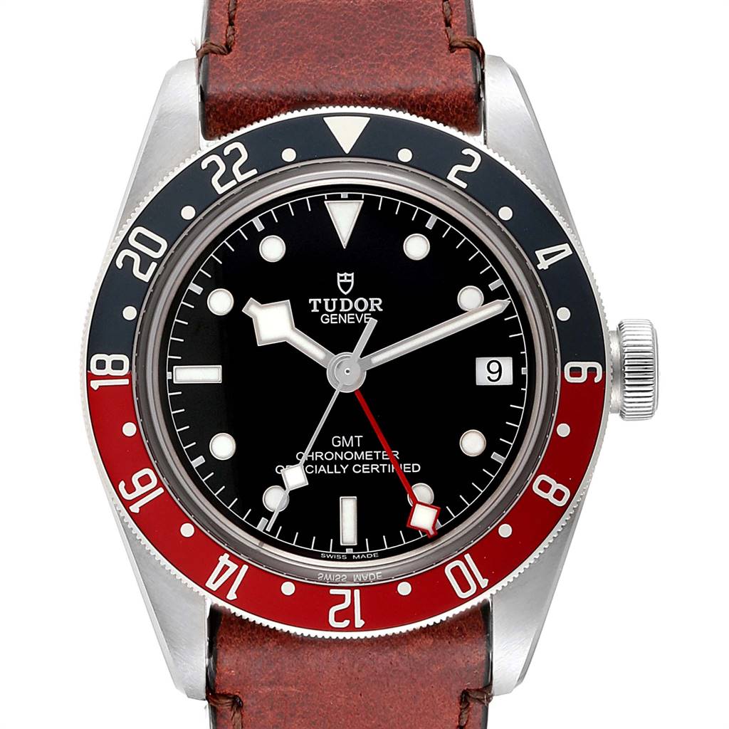 The image shows a frontal view of the Tudor Heritage Black Bay 79830RB Men's Stainless Steel Black Dial 79830RB Men's Stainless Steel Black Dial watch with a red and blue bezel and a brown leather strap.