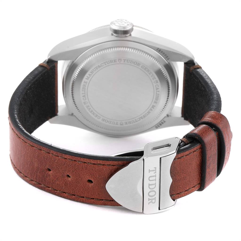This image shows the back view of a Tudor Heritage Black Bay 79830RB Men's Stainless Steel Black Dial 79830RB Men's Stainless Steel Black Dial watch, highlighting its case back and brown leather strap with a Tudor clasp.