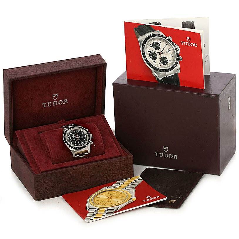 The Tudor Prince watch is shown from the front in an open display box, alongside booklets and another box.
