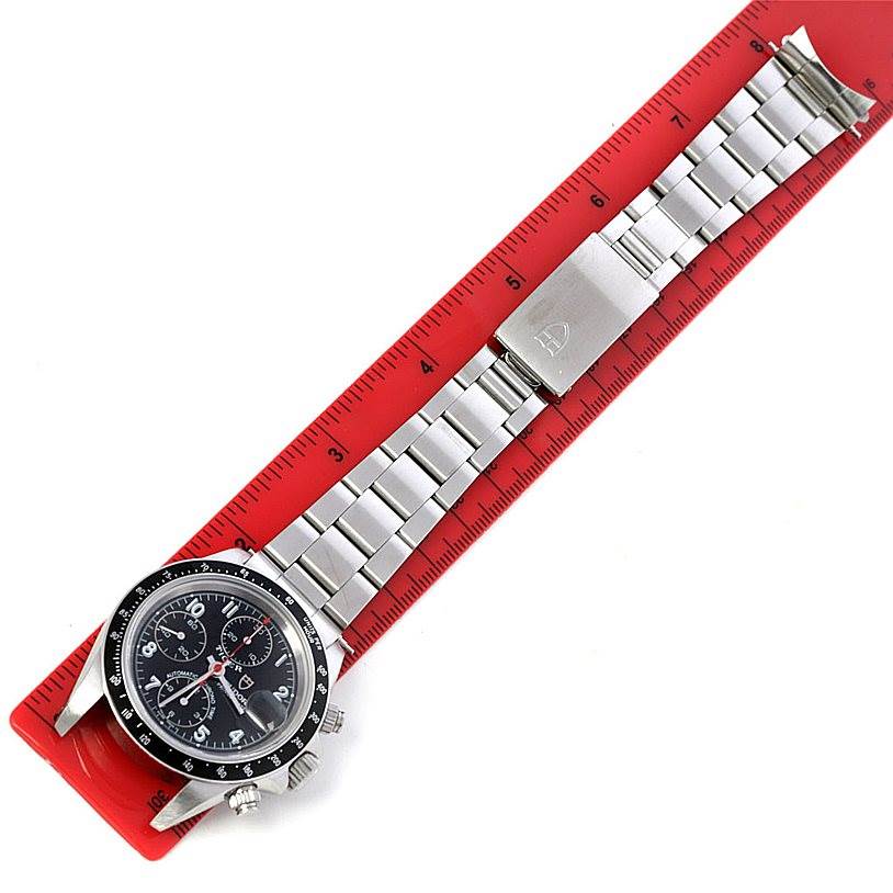 This image shows a Tudor Prince model watch with a metal bracelet, placed alongside a red ruler for size reference.