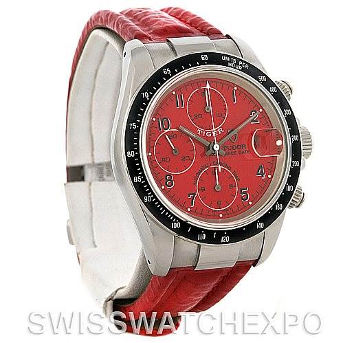 The image shows a Tudor Tiger 79260 Men's Stainless Steel Red Dial 79260 Men's Stainless Steel Red Dial watch from an angled view, highlighting its red dial, bezel, case, and red leather strap.