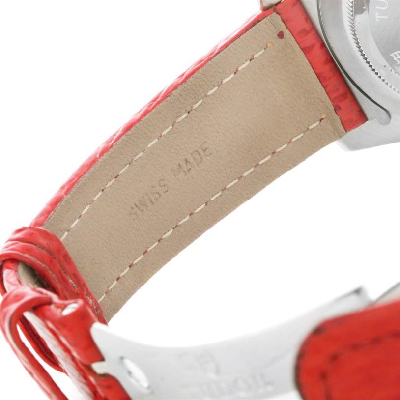 The image shows a close-up of the red leather strap and part of the case back of a Tudor Tiger 79270 Men's Stainless Steel Red Dial 79270 Men's Stainless Steel Red Dial model watch.