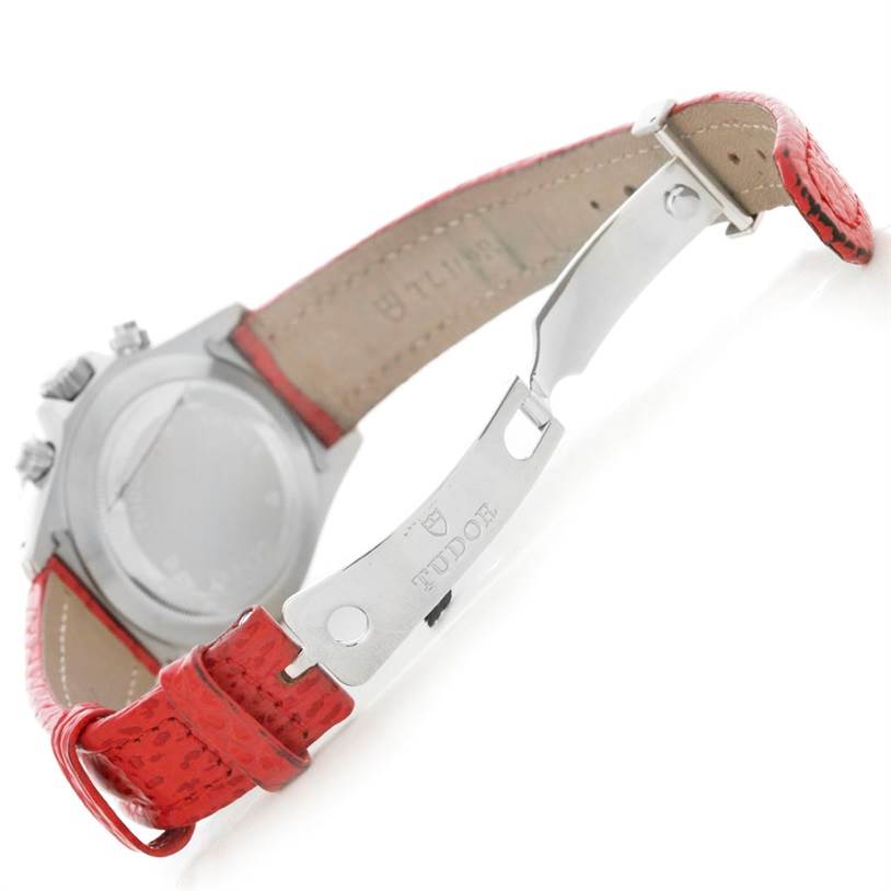The image shows the back and clasp of a Tudor Tiger 79270 Men's Stainless Steel Red Dial 79270 Men's Stainless Steel Red Dial model watch with a red strap.