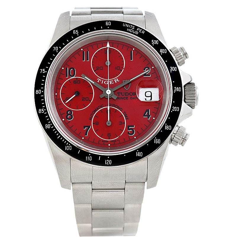 The image shows a front view of the Tudor Prince model watch with a red dial, chronograph sub-dials, and date magnifier.
