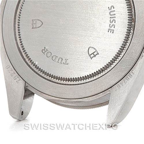 The image shows the case back of a Tudor Heritage Black Bay 79220R Men
s Stainless Steel Black Dial 79220R Men
s Stainless Steel Black Dial watch, featuring engravings and the brand logo.