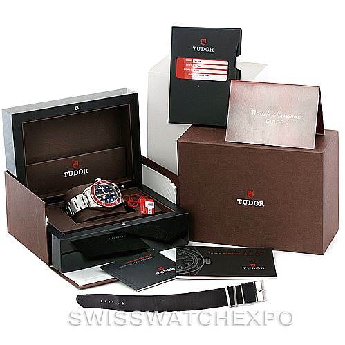 The image shows the Tudor Heritage Black Bay 79220R Men
s Stainless Steel Black Dial 79220R Men
s Stainless Steel Black Dial watch and its accessories, including the box, strap, booklets, and warranty cards, displayed from multiple angles.