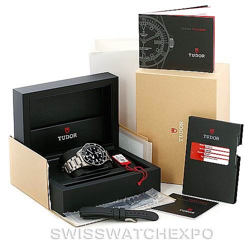 The Tudor Pelagos 25500TN Men's Titanium Black Dial 25500TN Men's Titanium Black Dial watch is shown from a front angle, accompanied by its box, manual, warranty card, and extra strap.