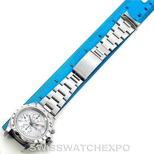 This image shows a Tudor Prince model watch laid flat next to a blue ruler, highlighting its bracelet and clasp.