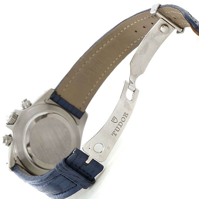 The image shows the side and back of a Tudor Tiger 79280 Men's Stainless Steel Blue Dial 79280 Men's Stainless Steel Blue Dial model watch, focusing on its clasp and partially open blue leather strap.