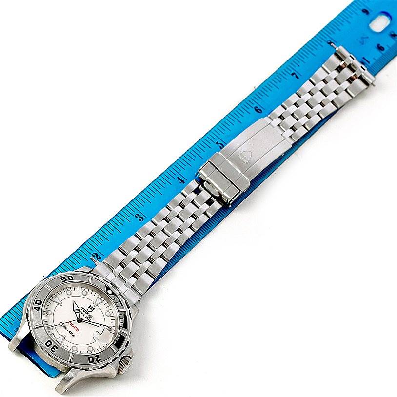 The image shows a Tudor Hydronaut 89190 Men's Stainless Steel Beige Dial 89190 Men's Stainless Steel Beige Dial watch placed beside a blue ruler, viewed from the side to display the face, bezel, and metal bracelet.