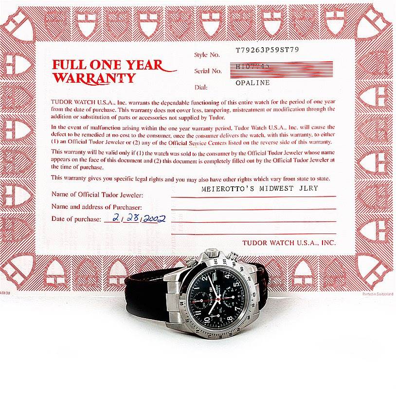 The Tudor Tiger 79280P Men's Stainless Steel Black Dial 79280P Men's Stainless Steel Black Dial watch is shown at an angle highlighting the face, bezel, and part of the leather strap, with a warranty certificate in the background.