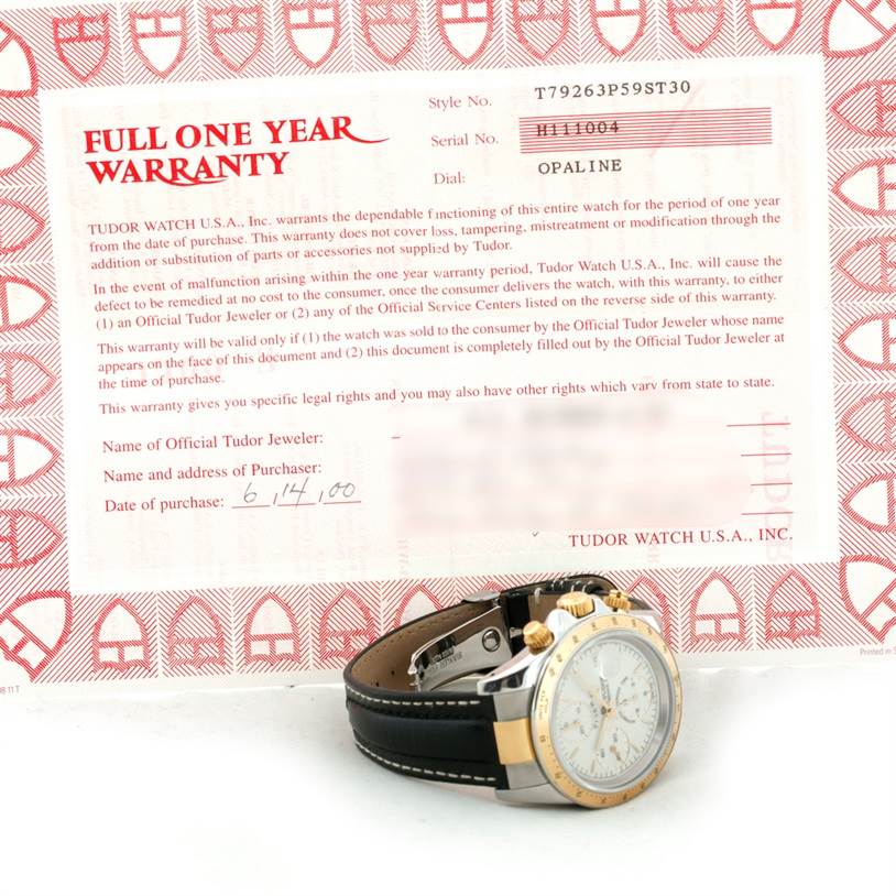 The image shows a Tudor Tiger 79263 Men's Steel and Gold (two tone) White Dial 79263 Men's Steel and Gold (two tone) White Dial model watch angled to display its face and part of the warranty paperwork.