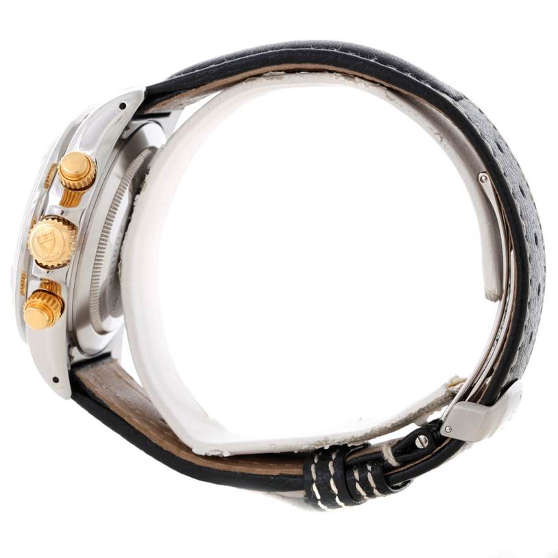 This side view of the Tudor Tiger 79263 Men's Steel and Gold (two tone) White Dial 79263 Men's Steel and Gold (two tone) White Dial watch shows the crown, pushers, and part of the leather strap.