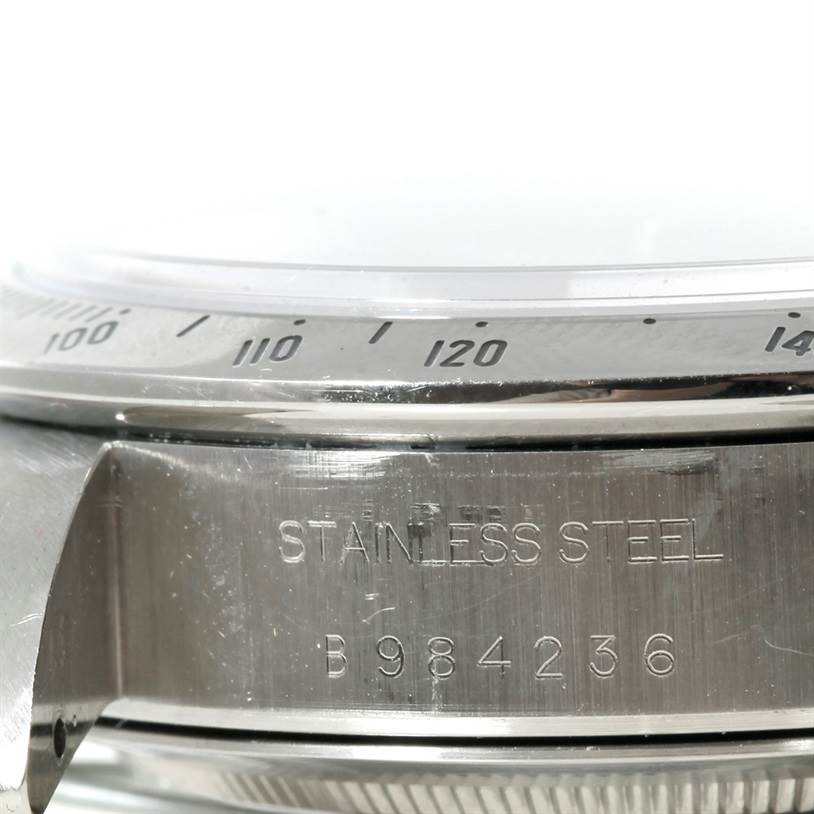 The image shows a close-up angle of the stainless steel case and engraved serial number of a Tudor Prince model watch.