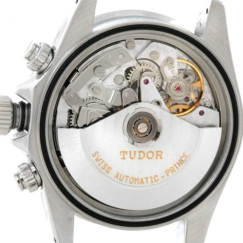 This image shows the internal mechanism and back of a Tudor Prince model watch with visible gears and engravings.