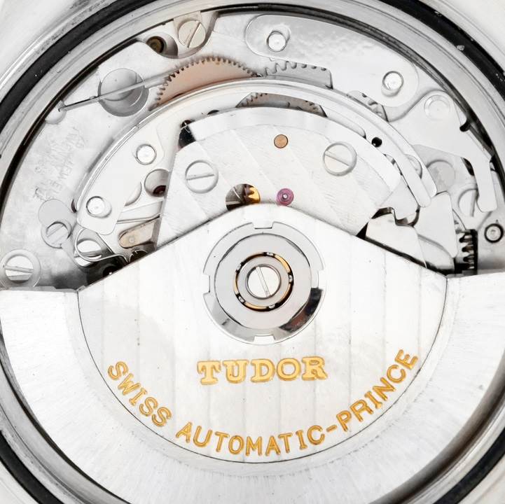 The image shows the inner mechanical movement of the Tudor Tiger 79280 Men's Stainless Steel Green Dial 79280 Men's Stainless Steel Green Dial model, highlighting its gears and "Swiss Automatic-Prince" inscription.