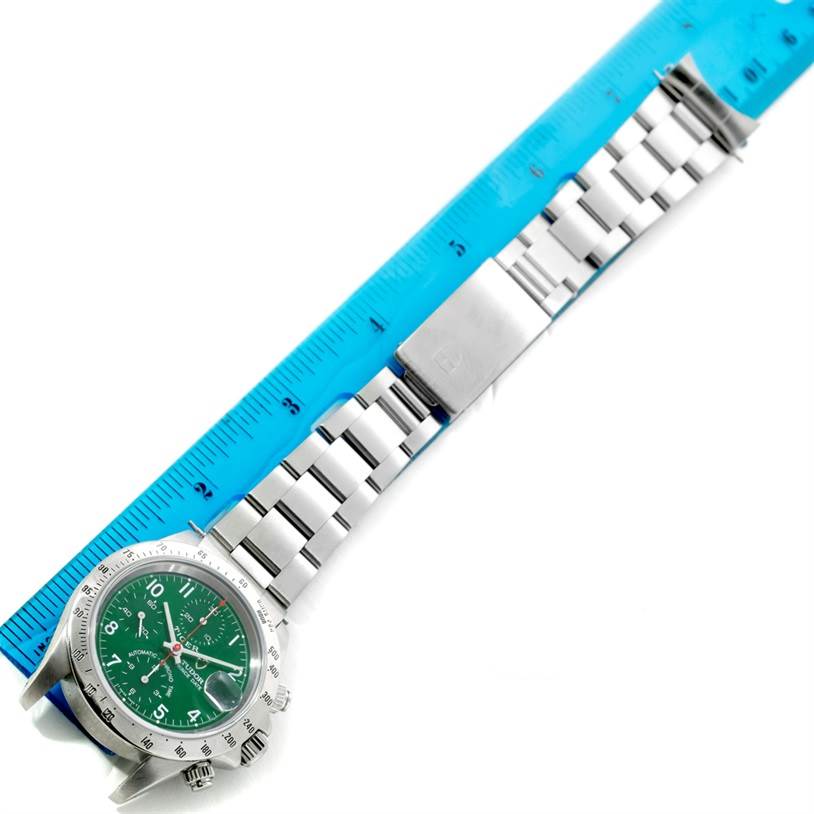 The Tudor Tiger 79280 Men's Stainless Steel Green Dial 79280 Men's Stainless Steel Green Dial watch is shown from an angled top view, displaying its green dial, metal bracelet, and clasp alongside a ruler.