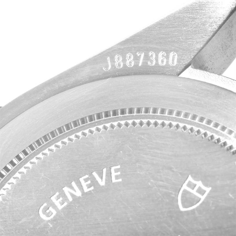 The image shows a close-up of the back casing of a Tudor Heritage Black Bay 79220 Men
s Stainless Steel Black Dial 79220 Men
s Stainless Steel Black Dial watch, revealing part of the serial number and "GENEVE" engraving.