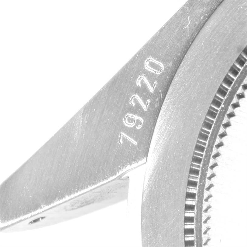 The image shows a close-up of the case lug and part of the bezel of a Tudor Heritage Black Bay 79220 Men
s Stainless Steel Black Dial 79220 Men
s Stainless Steel Black Dial watch, with the model number engraved.