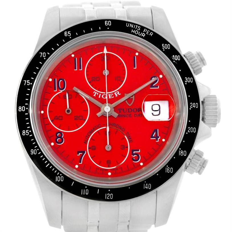 The Tudor Prince model watch is shown from the front, displaying its red dial, chronograph subdials, date window, and bezel.