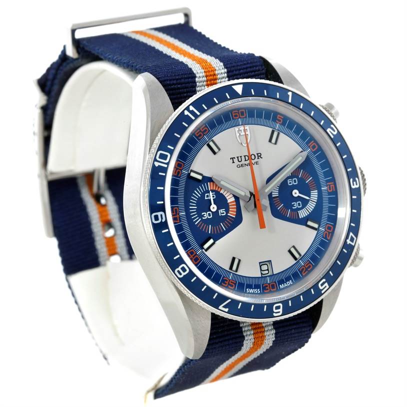 The image shows a Tudor Heritage Chrono 79220R Men's Stainless Steel Blue Dial 79220R Men's Stainless Steel Blue Dial watch at a three-quarter angle, highlighting the face, bezel, and fabric strap.